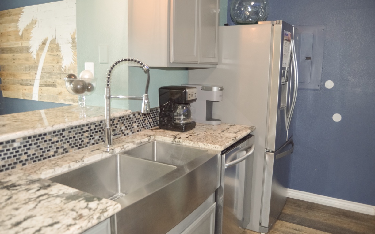 Your sleek kitchen features granite counters, stainless appliances, and a professional faucet for easy meal prep.