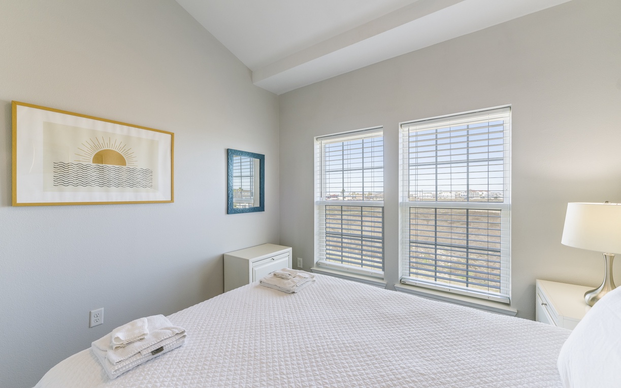 Drift off in your serene bedroom where soft linens meet natural light streaming through elegant blinds, creating the perfect retreat.