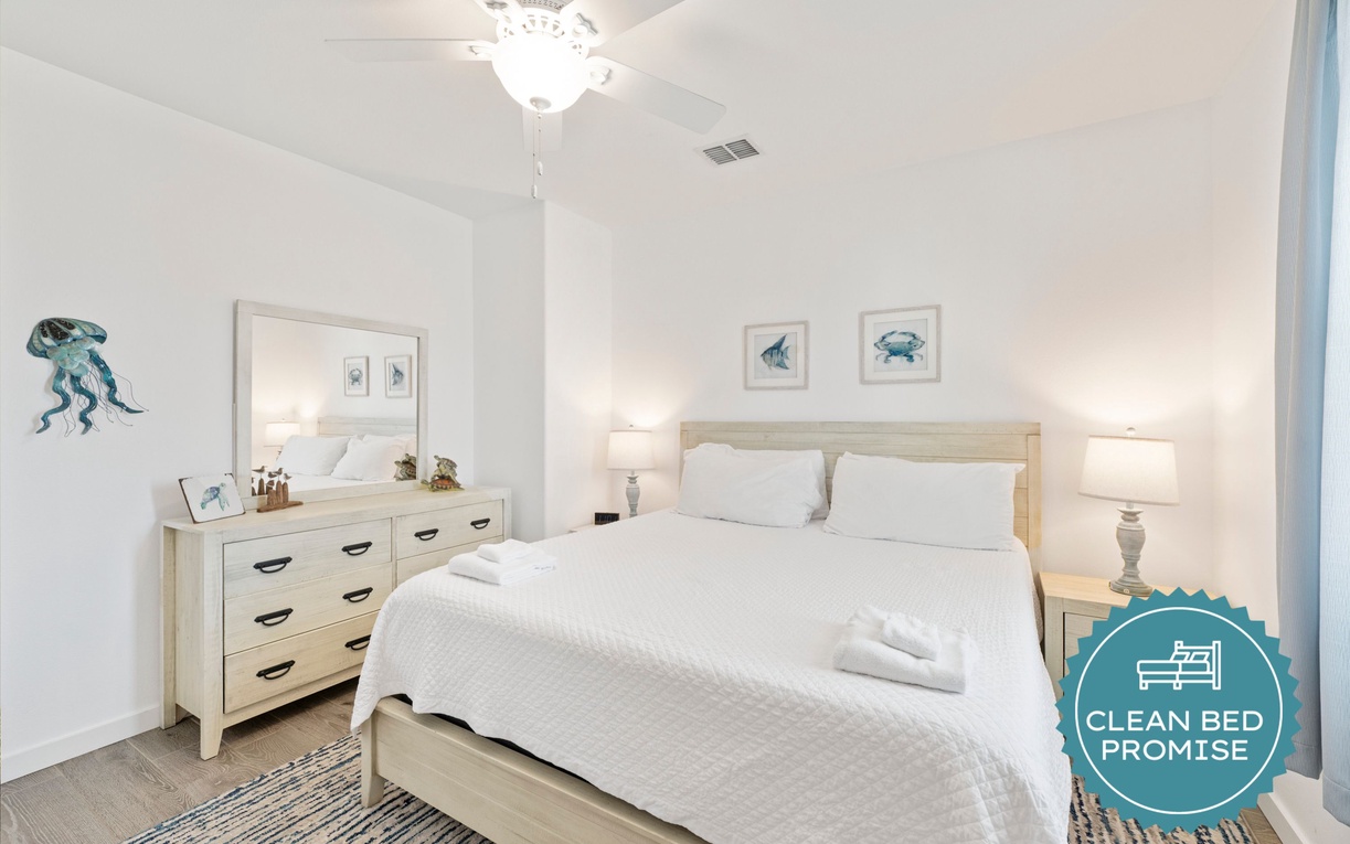 Drift into peaceful slumber in your serene bedroom with crisp linens, coastal artwork, and gentle lighting that creates the perfect retreat.