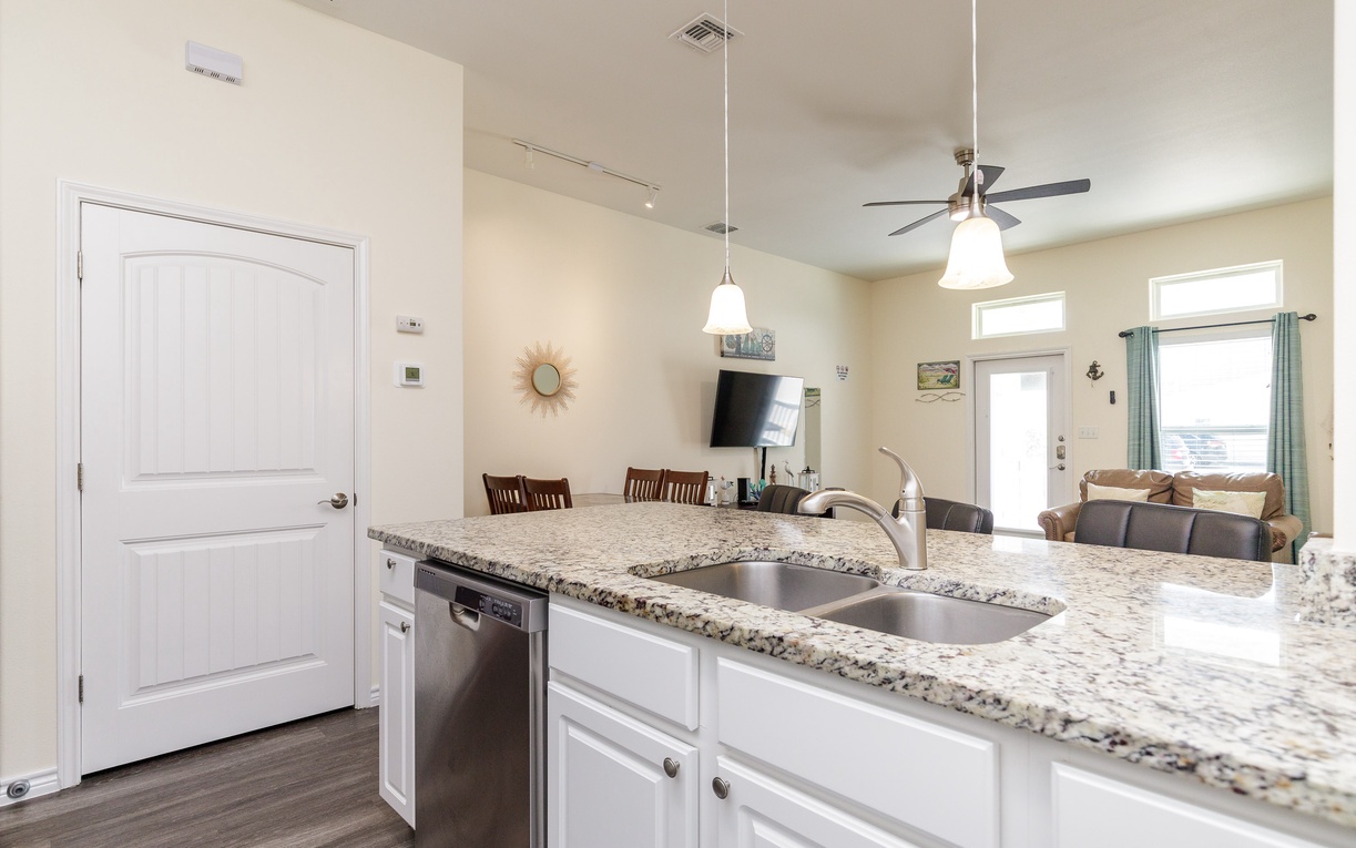Your gourmet kitchen features granite countertops and modern appliances, flowing seamlessly into the dining and living areas for perfect entertaining.