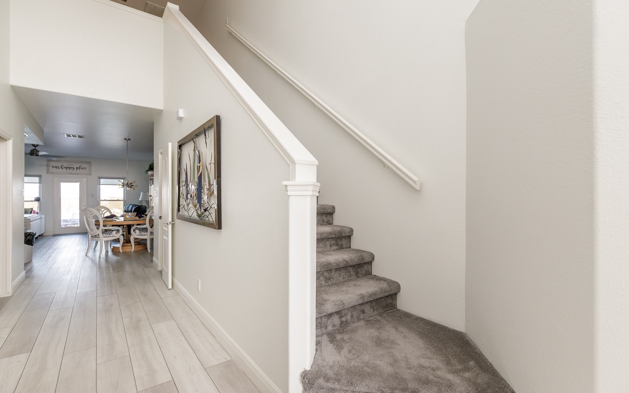 You'll love the elegant staircase leading to your private upstairs retreat, while the open layout connects your living spaces beautifully.