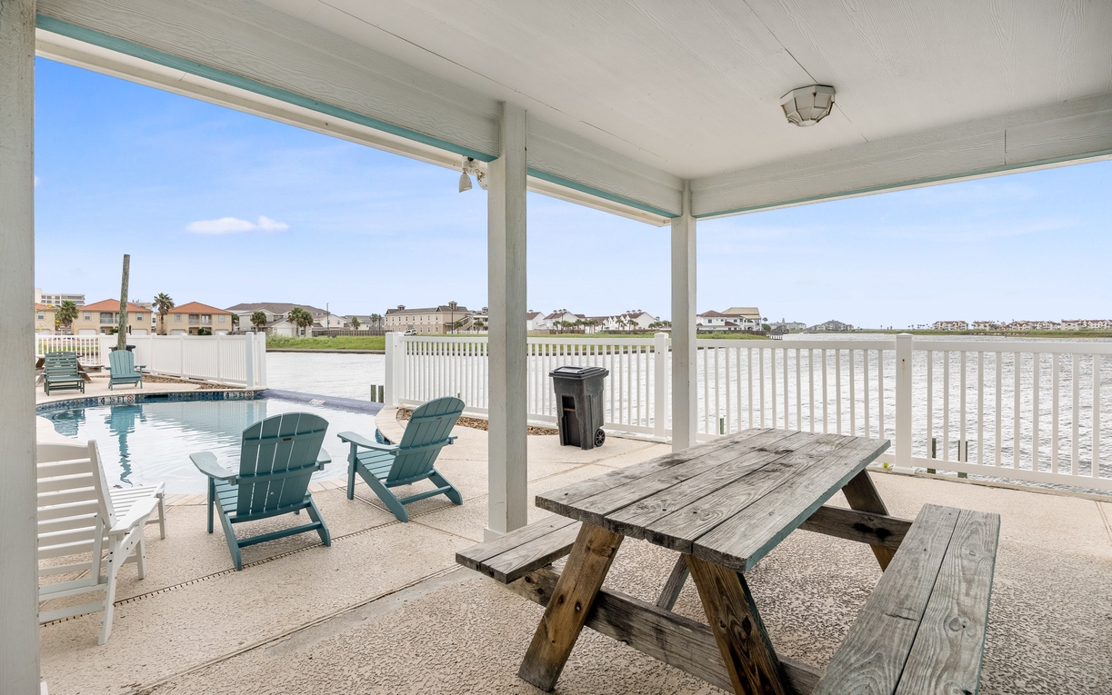 Relax under your covered patio with pool views and outdoor dining table, perfect for morning coffee or evening meals.