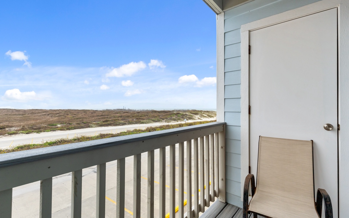 Take in stunning natural landscape views from your private balcony, with blue skies stretching across rolling terrain.