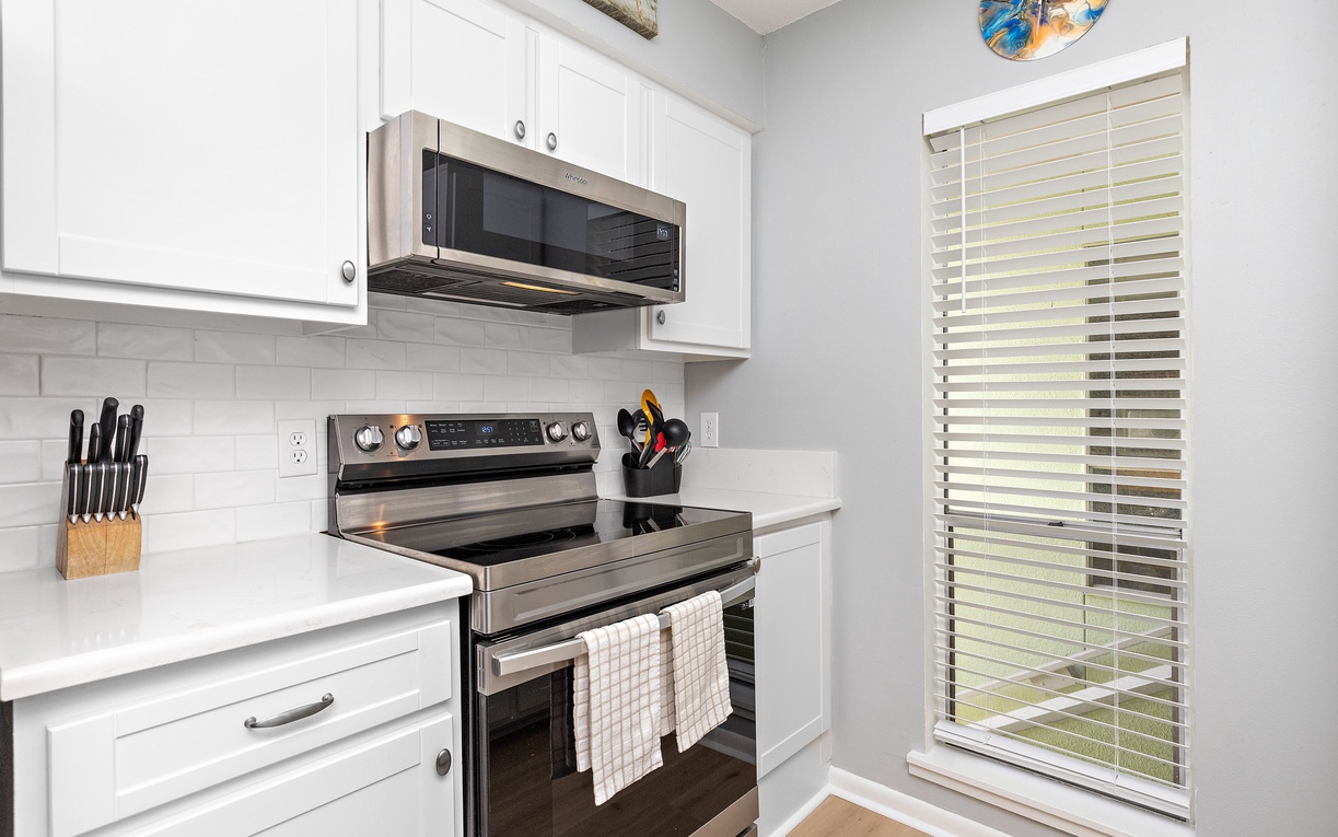 Your bright kitchen features modern appliances and crisp white cabinetry, perfect for preparing meals during your stay.