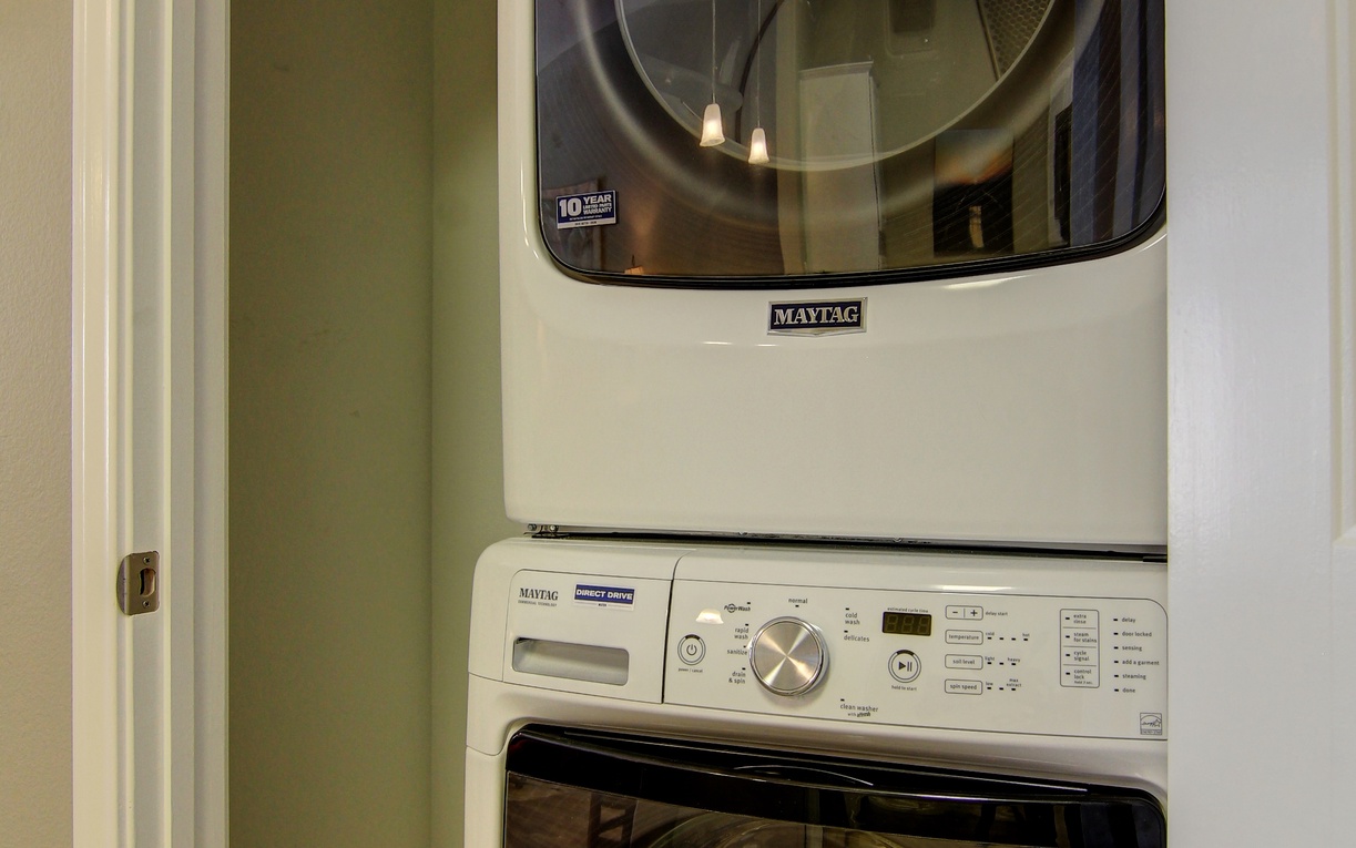 Keep your favorite outfits fresh with your own washer and dryer tucked neatly in this convenient laundry closet.