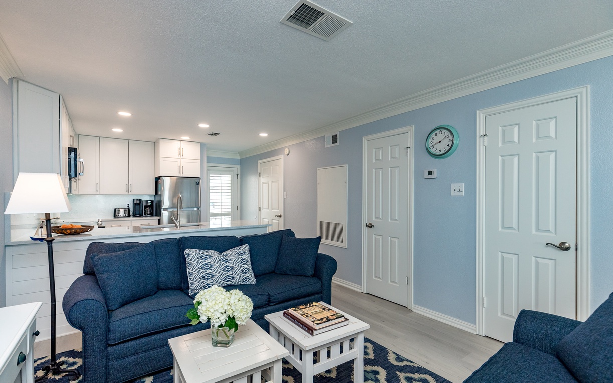 Unwind in your bright, coastal-inspired living space where soothing blue tones and comfortable seating create the perfect retreat after exploring.