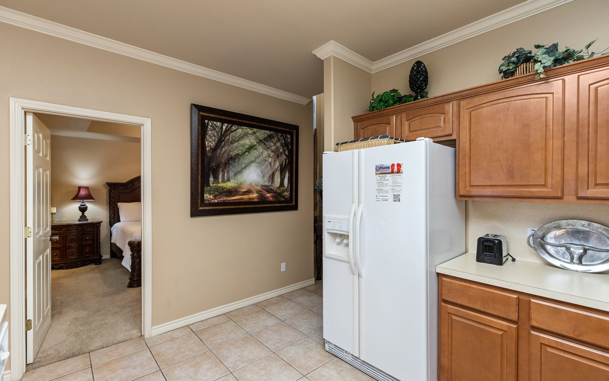Your kitchen offers warm wood cabinets and modern appliances for preparing home-cooked meals during your stay.