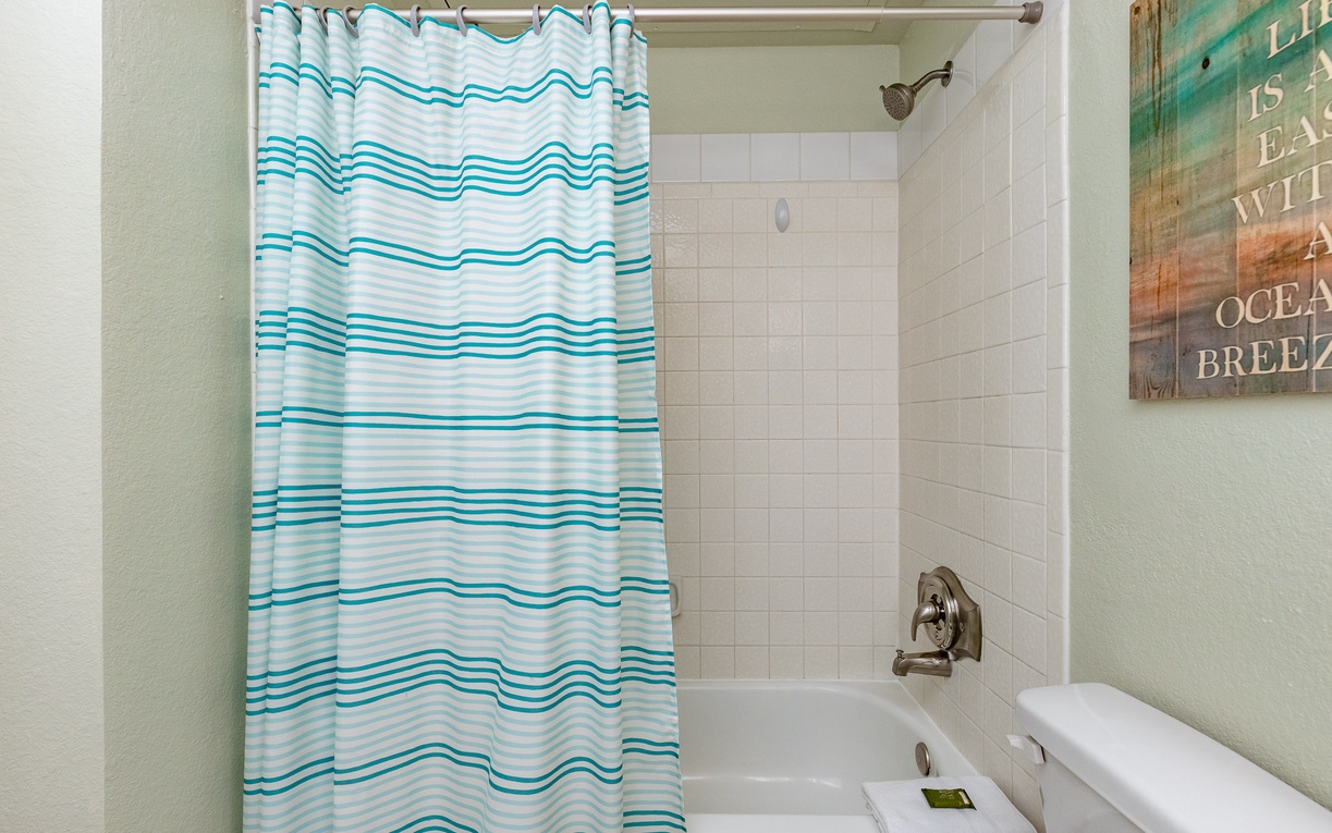 Refresh yourself in this bright bathroom with cheerful ocean-themed touches and a relaxing tub-shower combo.