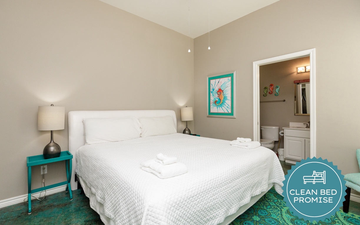 Sink into crisp white linens and enjoy your peaceful retreat with stylish turquoise accents and an ensuite bathroom.