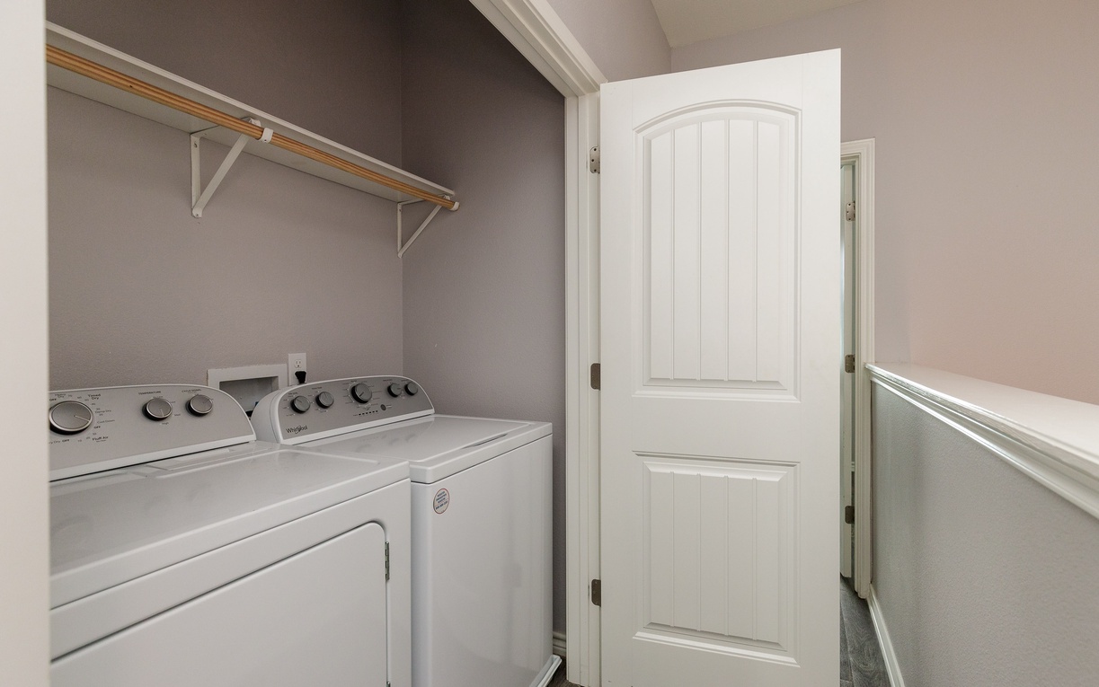 Your dedicated laundry space keeps travel light with full-size washer and dryer plus hanging rod for easy garment care.