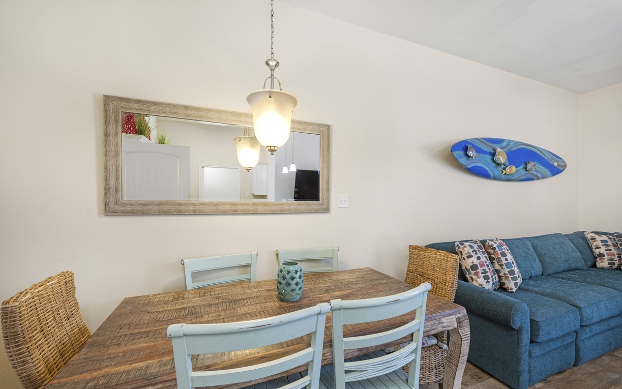 Gather around your rustic dining table for memorable meals while relaxing on the plush sectional sofa in this bright, coastal-themed space.