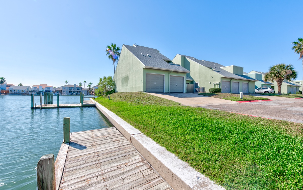 Waterfront property complex featuring private docks and boat access along scenic canal waters.