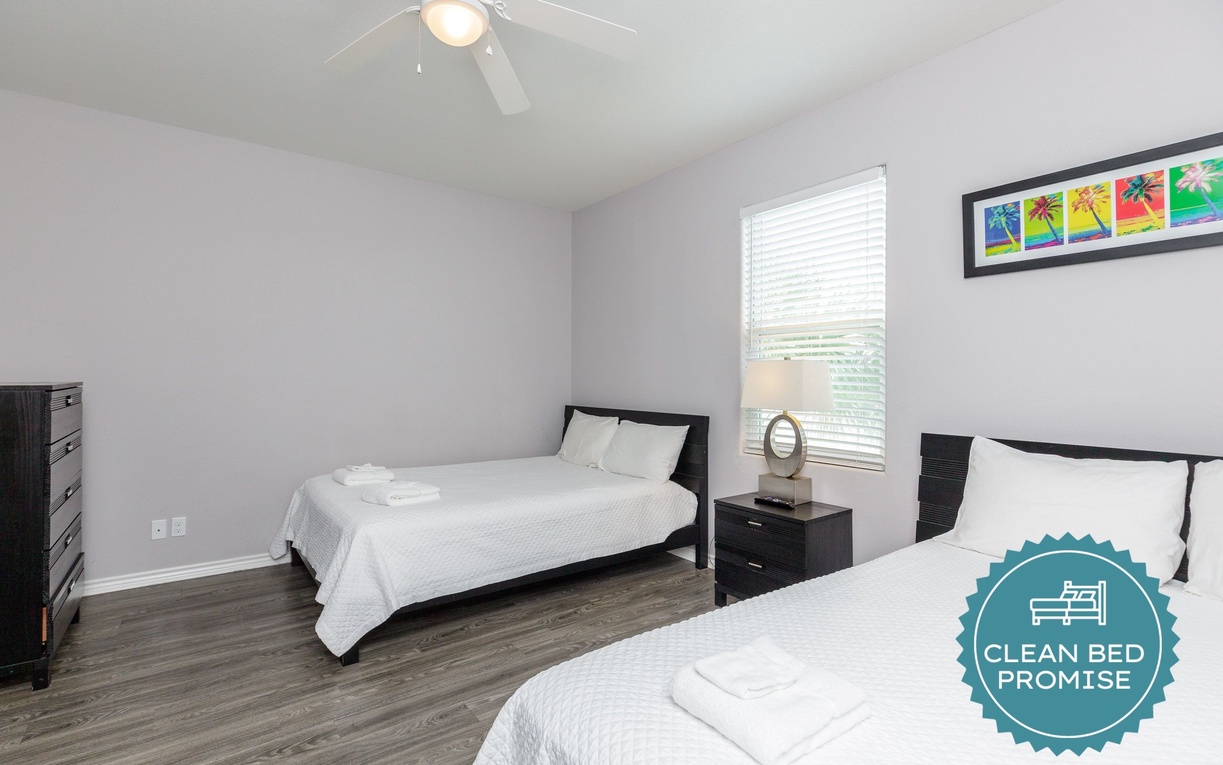 Rest peacefully in this bright twin bedroom with fresh linens and modern touches.