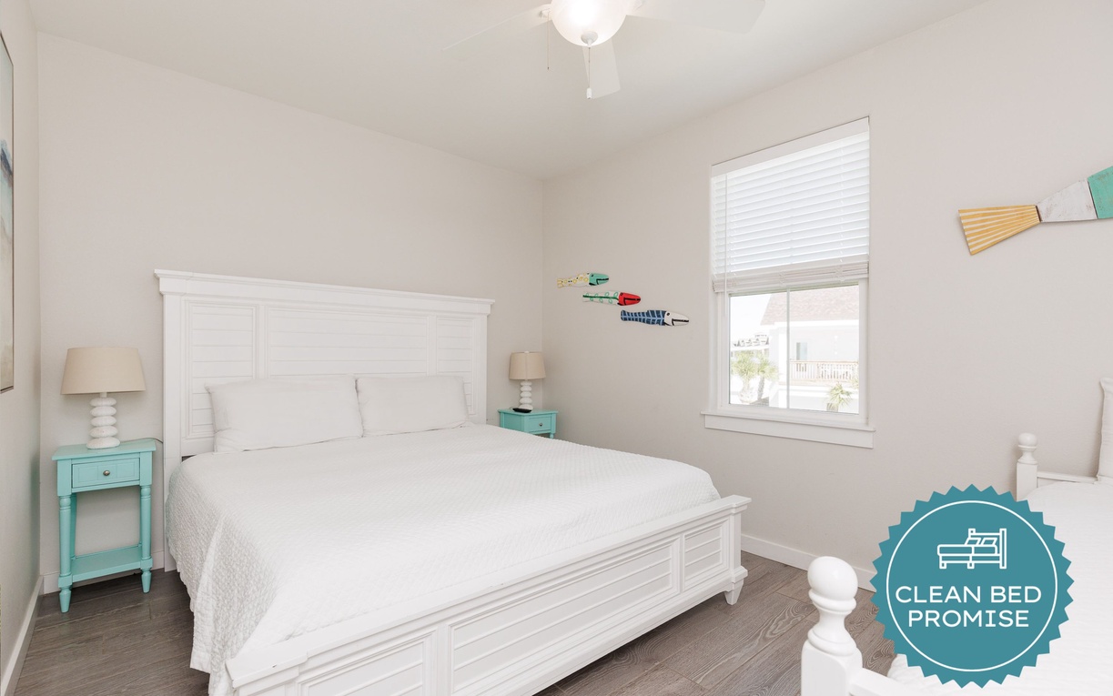 Rest peacefully in your bright, airy bedroom with crisp white linens and charming coastal touches that make every morning feel refreshing.