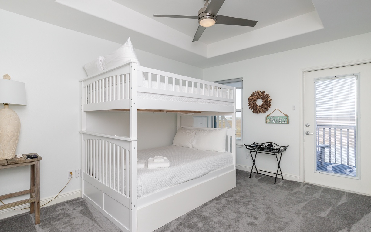 Your little ones will love this cozy bedroom with its crisp white bunk bed and tray ceiling with ceiling fan for comfort.
