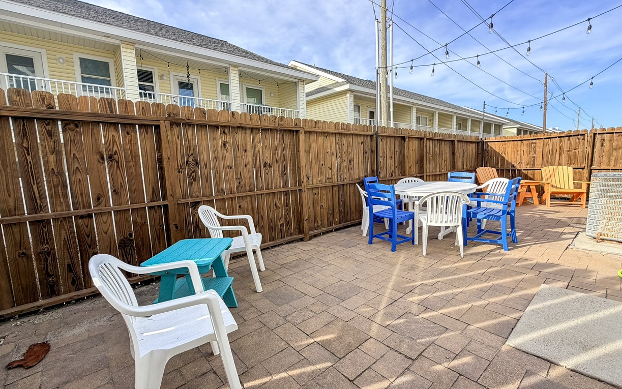 Enjoy your private patio with colorful outdoor seating and dining space, perfect for morning coffee or evening relaxation.