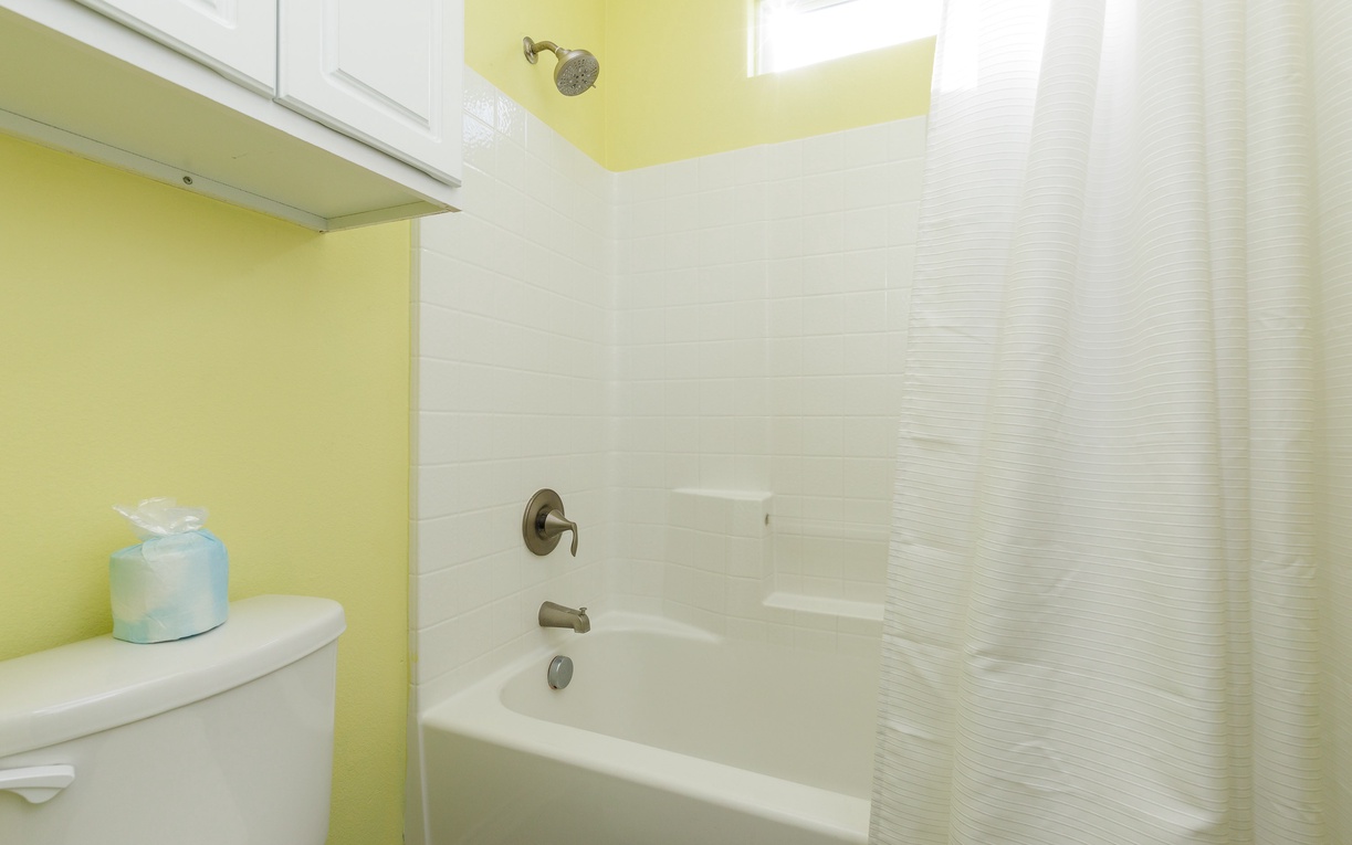 Relax in your bright, cheerful bathroom with a full tub-shower combo and sunny yellow walls that start each morning with warmth.