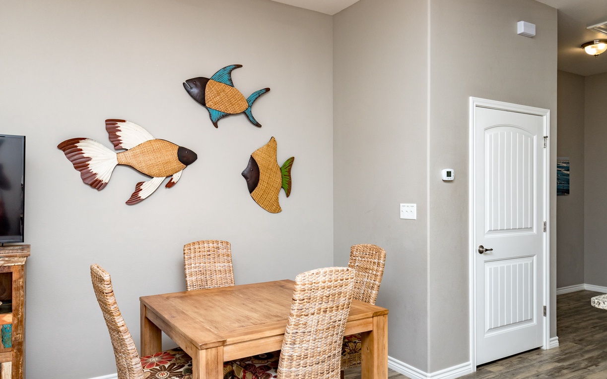 Gather around your charming dining table where whimsical fish art creates a coastal atmosphere for memorable meals together.