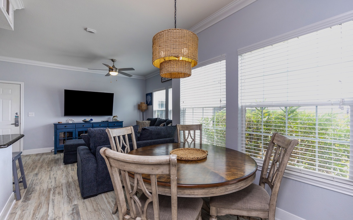Gather around your elegant dining table while tropical breezes flow through bright windows, creating the perfect setting for memorable meals.