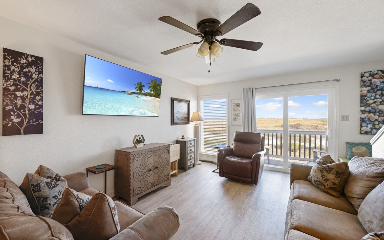 Unwind in your spacious living room with comfortable seating, large TV, and peaceful balcony views.