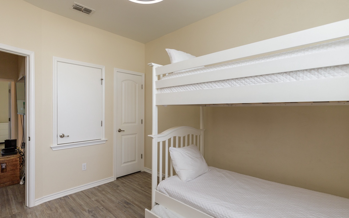 Rest comfortably in this cozy bunk bed setup with a trundle bed, 3 twin beds