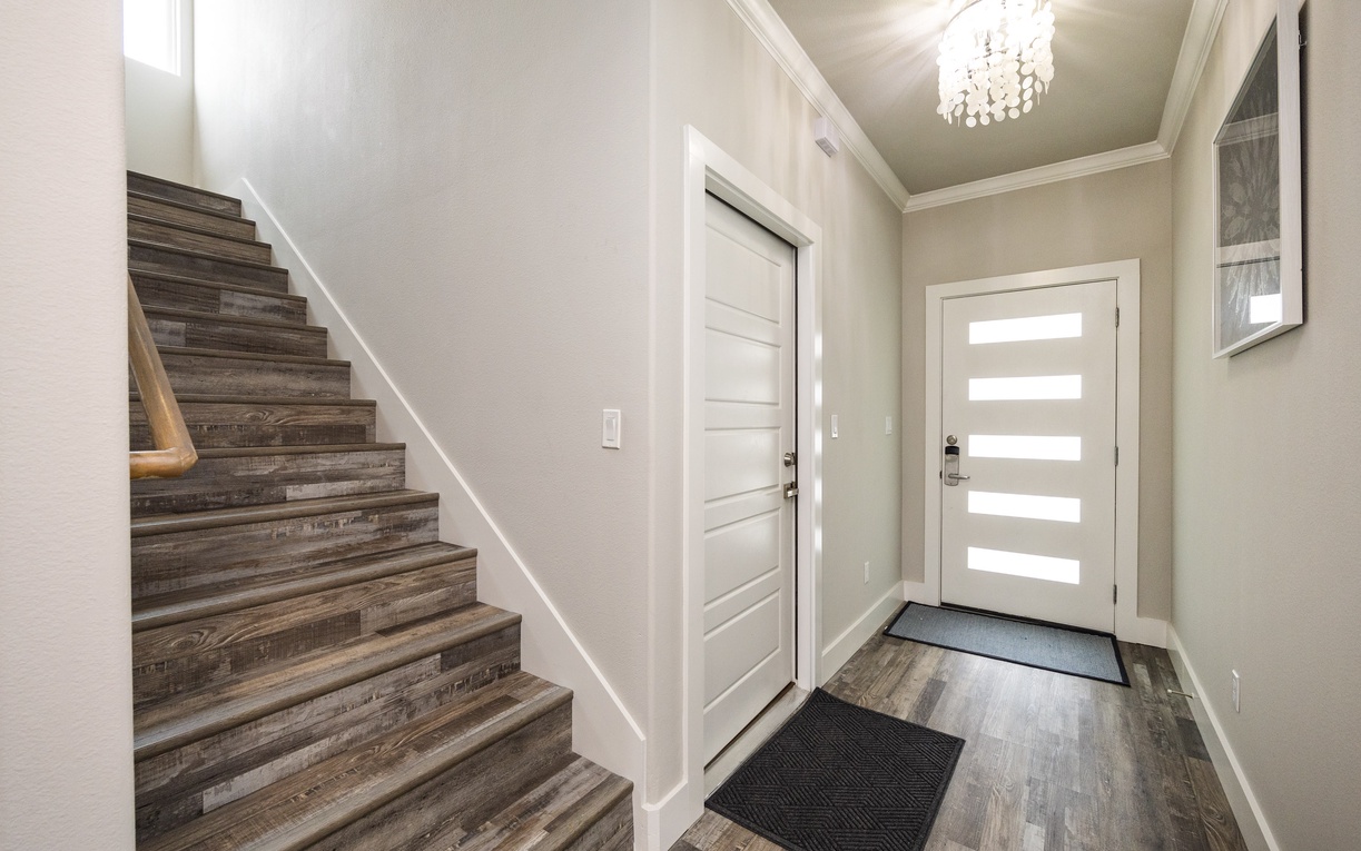 Step into your welcoming entryway featuring elegant wood floors, soft lighting, and thoughtful design touches that set the tone for your stay.