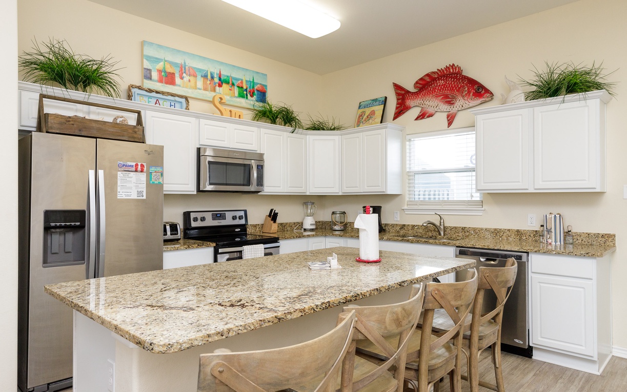 Cook memorable meals in your fully-equipped kitchen featuring granite countertops, stainless appliances, and a spacious island perfect for gathering.