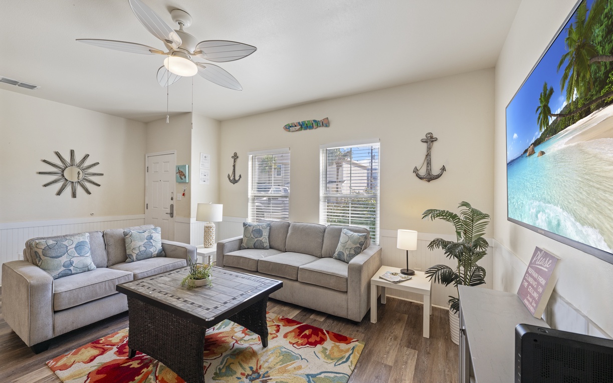Unwind in your bright living room with coastal décor and modern comforts, where tropical touches create your perfect beach getaway retreat.