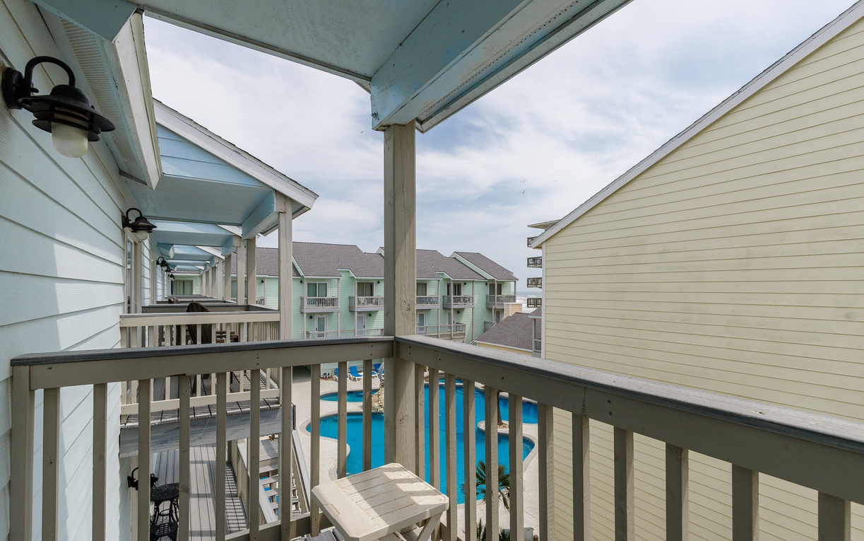 From your guest bedroom you can relax on your private covered balcony with pool views