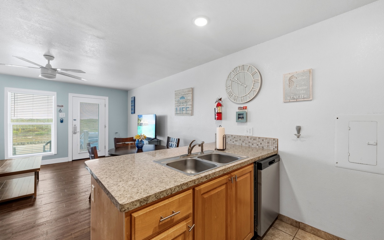Your open-plan space blends kitchen convenience with living comfort—cook, relax, and enjoy water views through bright windows that flood the room with natural light.