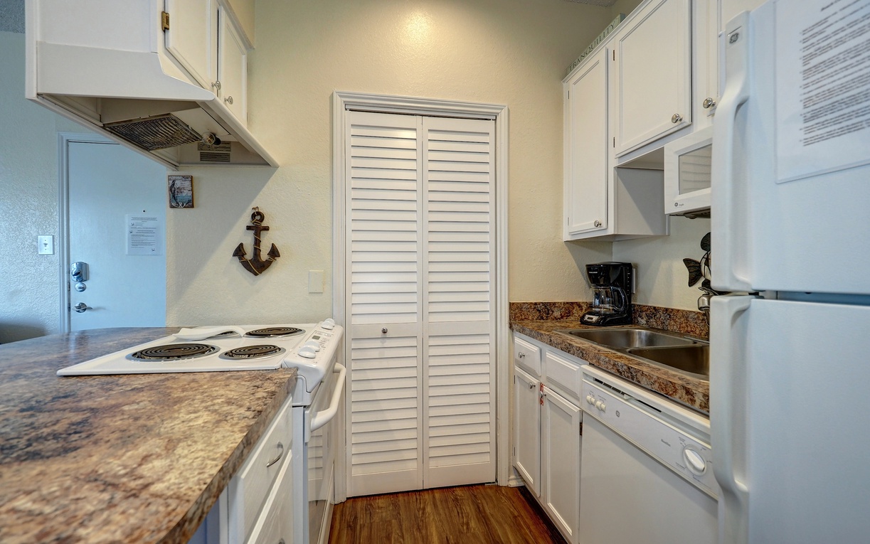 Your fully equipped galley kitchen features granite counters, white appliances, and charming nautical touches for easy meal prep.