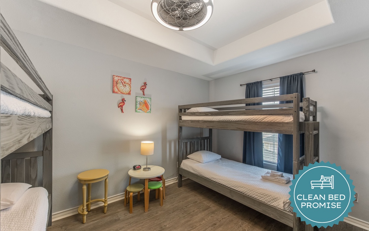 Your kids will love this cheerful bedroom with sturdy bunk beds and playful coastal artwork creating the perfect space for adventure dreams.