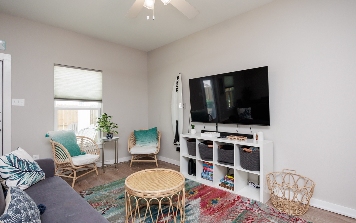 Unwind in your stylish living room with boho-chic touches, large TV for movie nights, and comfortable seating perfect for relaxation.