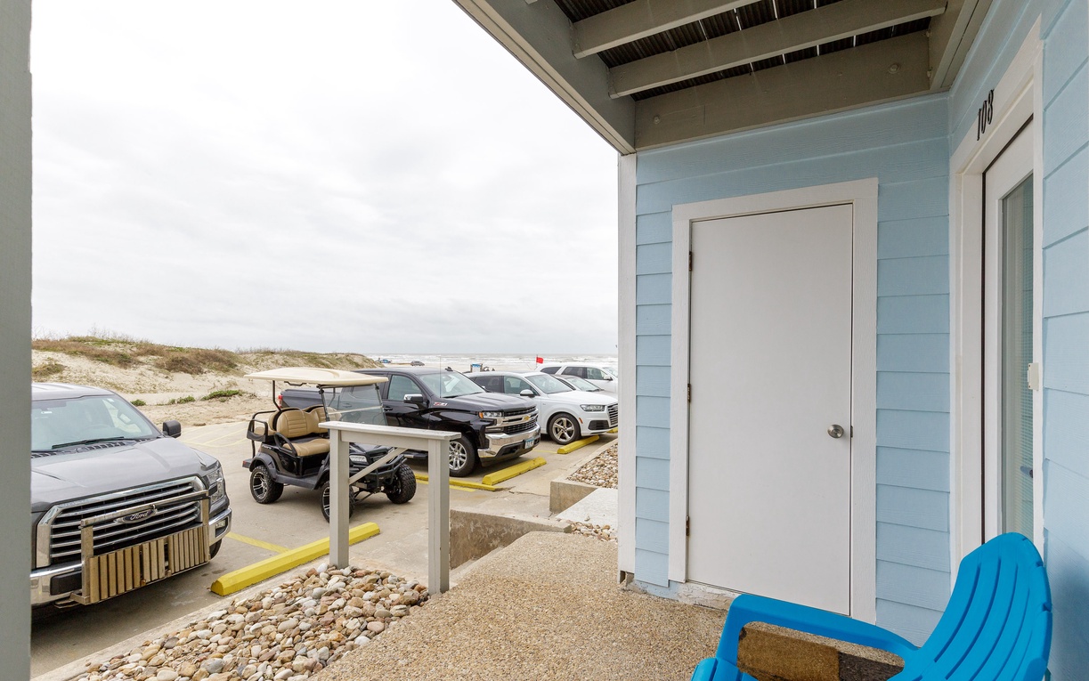 Step out onto your private porch and soak in the coastal atmosphere with beach dunes stretching beyond.