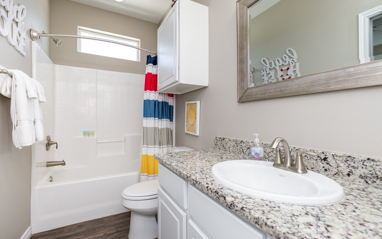 Refresh in your bright, clean bathroom featuring granite counters, ample storage, and a relaxing tub-shower combo.