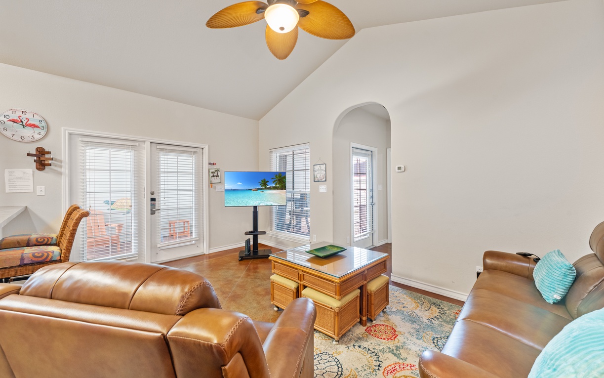 Sink into plush leather seating while the tropical breeze flows through your bright, airy living space complete with entertainment center.