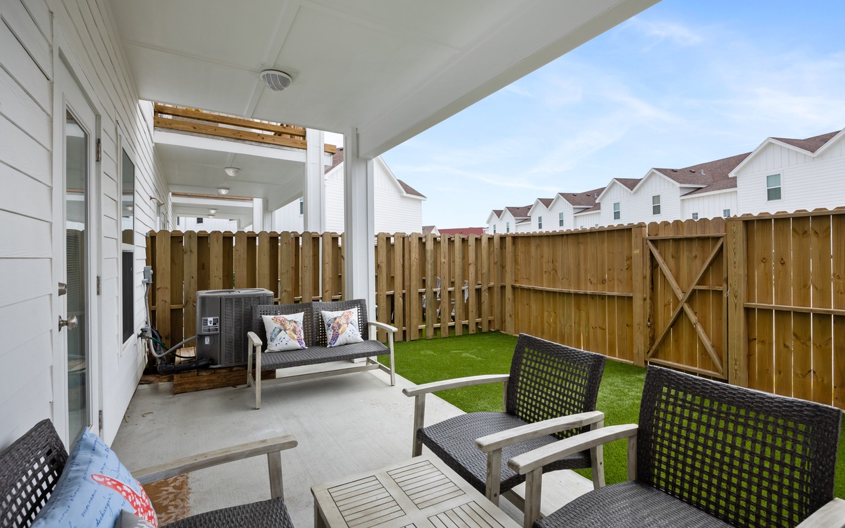 Unwind on your private covered patio with comfortable seating and a peaceful fenced yard—perfect for morning coffee or evening relaxation.