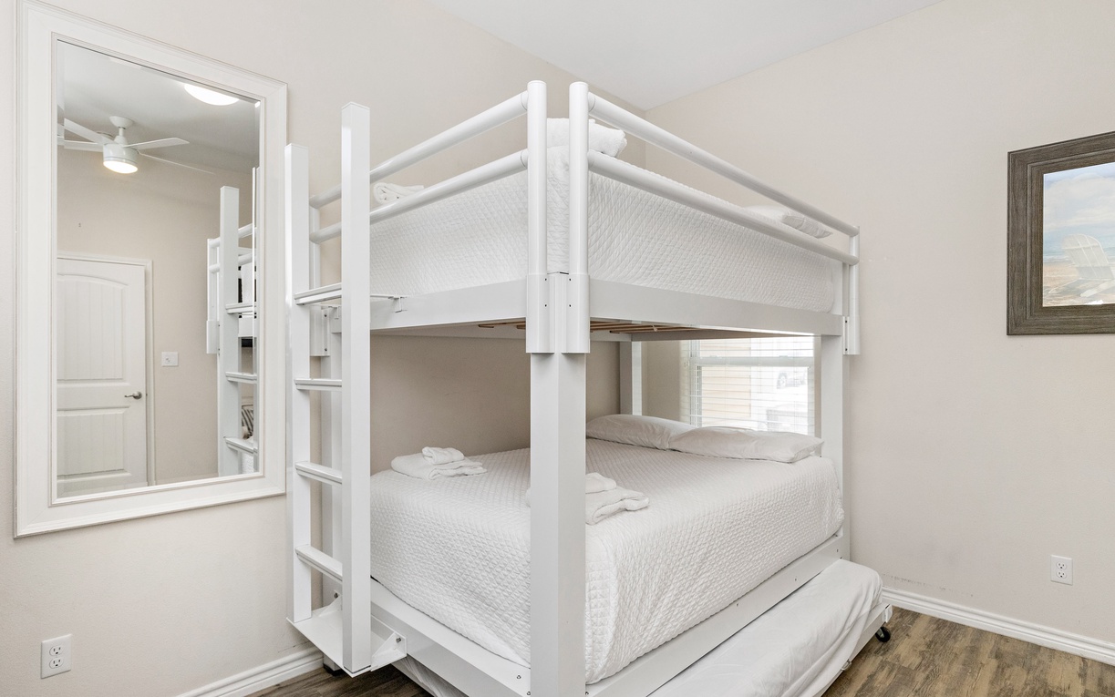 Your kids will love this bright white bunk bed with crisp linens and a cozy trundle for extra sleepover fun.