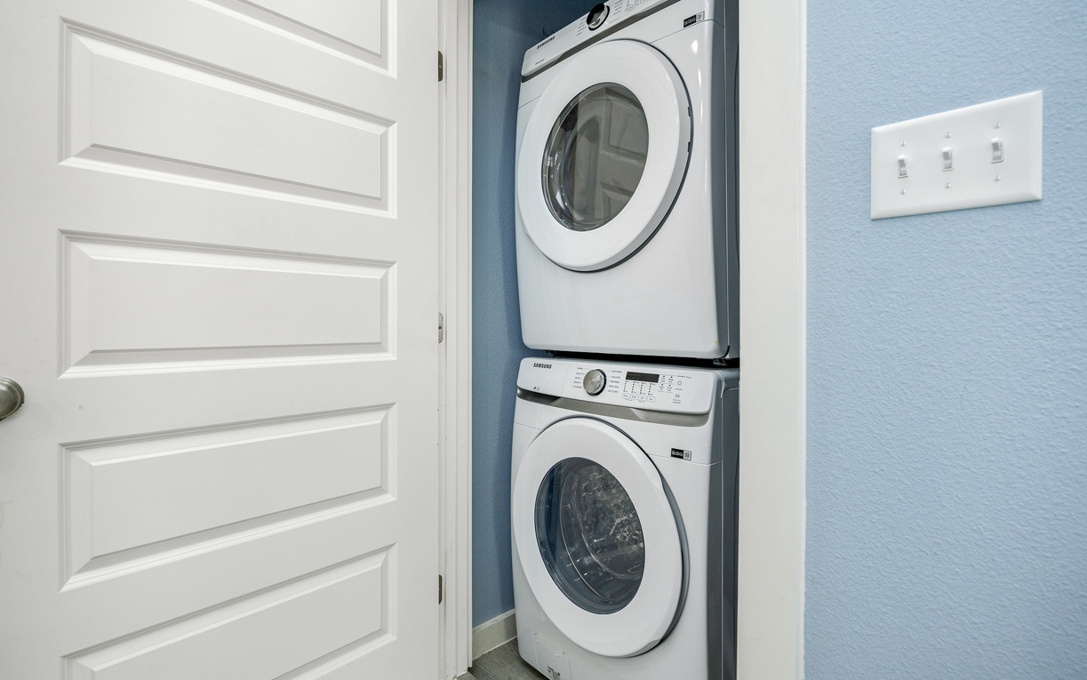 Keep your clothes fresh during your stay with convenient in-unit laundry facilities tucked neatly into this organized closet space.