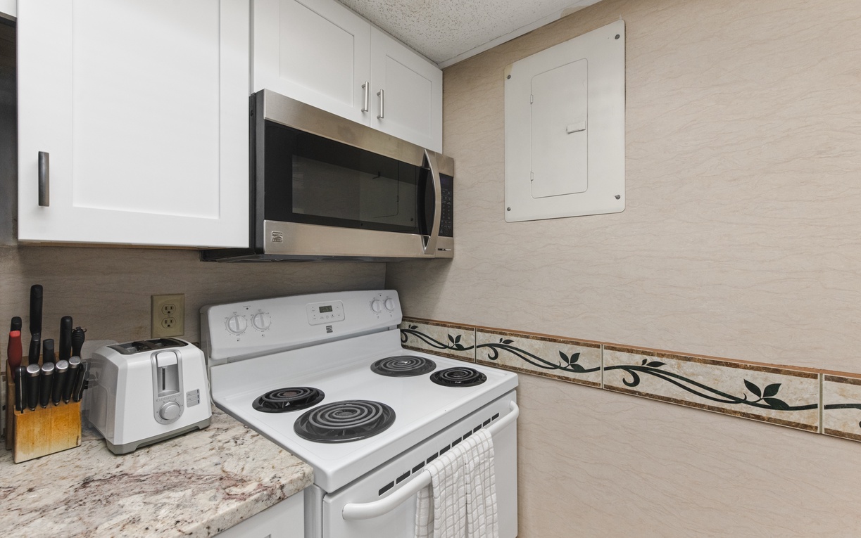 Your fully equipped kitchen awaits with modern appliances and granite counters, perfect for preparing memorable meals during your stay.