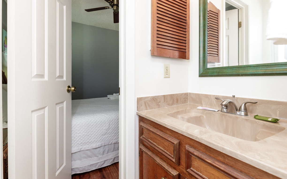 Your private ensuite bathroom connects seamlessly to your cozy bedroom, featuring marble countertops and warm wood finishes for a refined retreat.