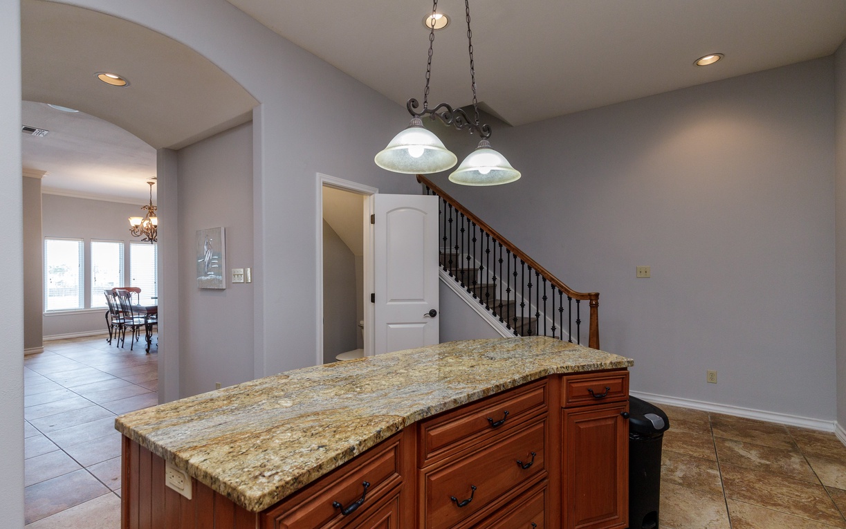 Your kitchen island becomes the heart of this open space, with granite countertops perfect for meal prep and casual dining.