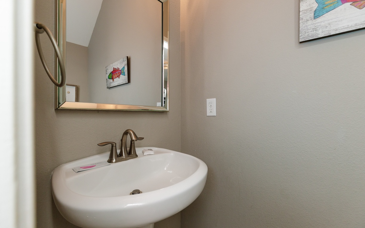 Refresh in your private bathroom with modern fixtures and charming artwork creating a welcoming space for your stay.