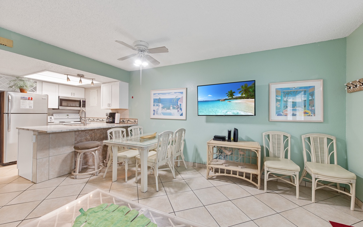 Step into your coastal-inspired living space where soothing seafoam walls create instant vacation vibes while you dine and unwind.