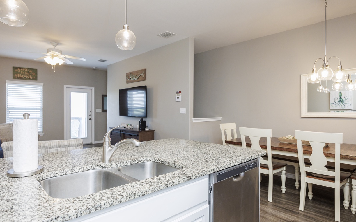 Your bright open kitchen flows seamlessly into the dining area, with granite countertops and modern appliances perfect for preparing memorable meals together.