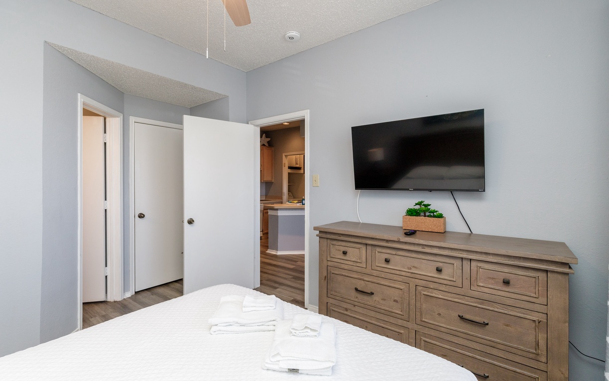 Unwind in your serene bedroom with a flat-screen TV and ample storage for all your belongings.