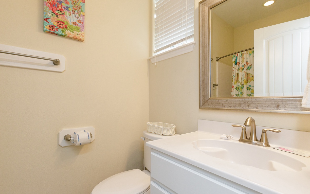 Your private bathroom offers modern comfort with elegant marble counters, bright natural light, and thoughtful artwork creating a serene start to each day.