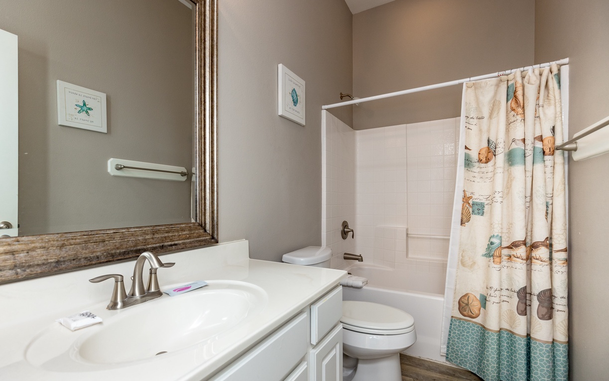 Relax in your coastal-themed bathroom with nautical touches and a soaking tub for unwinding after beach days.