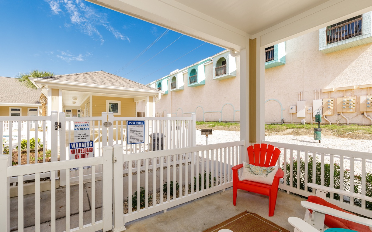 Relax in your colorful outdoor chair while enjoying the protected balcony space with charming property views.
