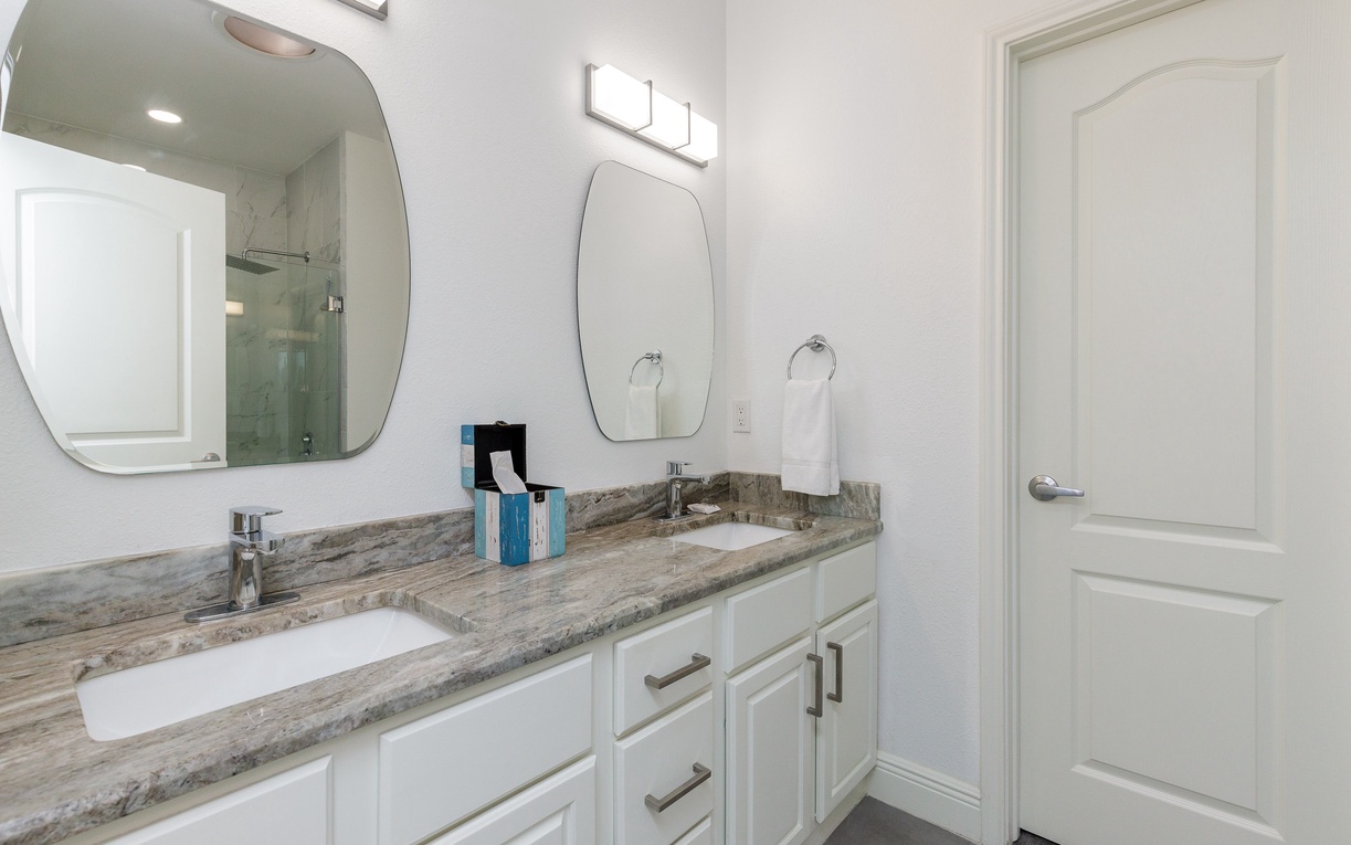Refresh in your stylish double-vanity bathroom with elegant granite counters, modern fixtures, and plenty of space to get ready.